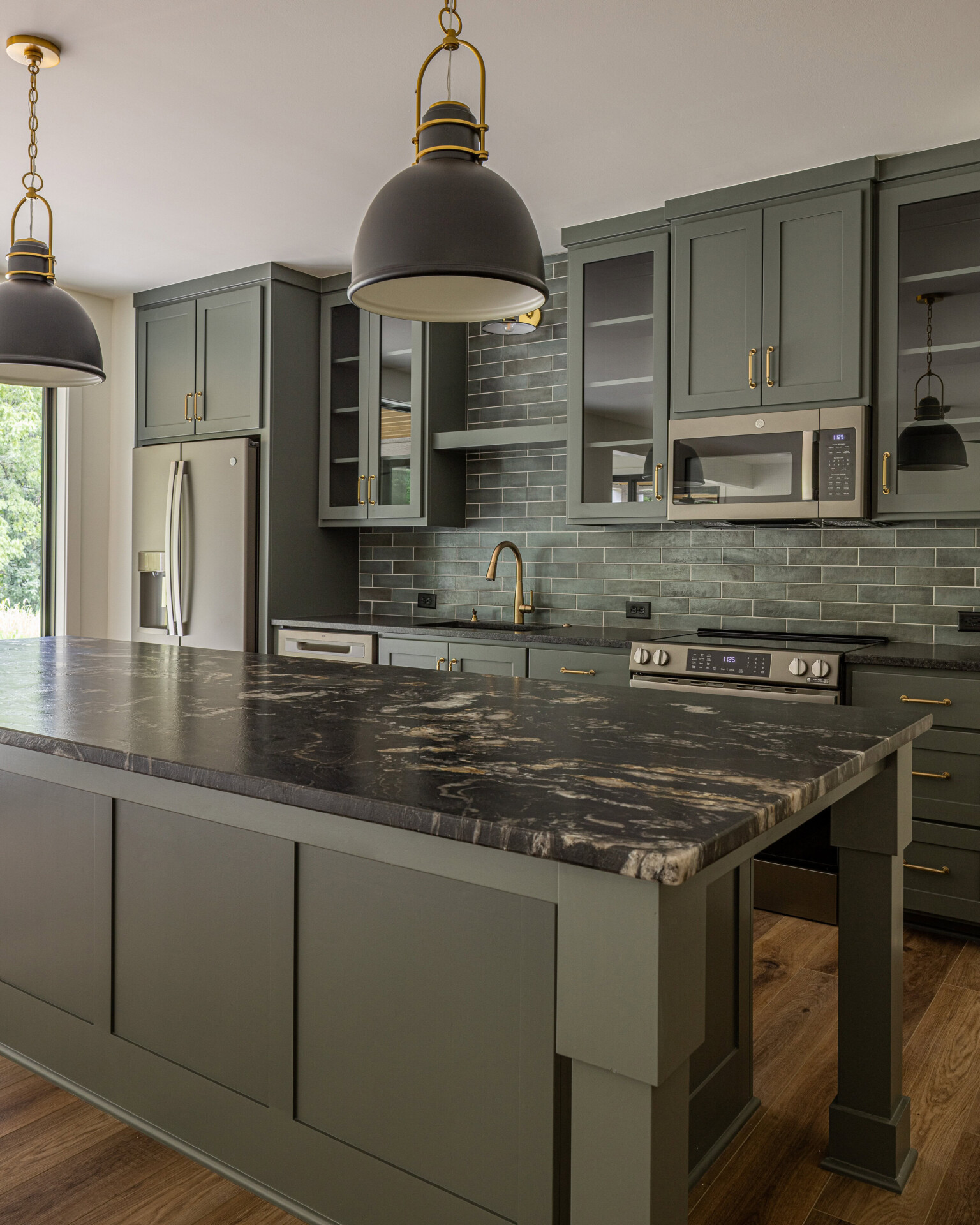 Modern Kitchen Design with Gray Cabinets Contemporary kitchen with gray cabinets, marble island, and pendant lighting.
