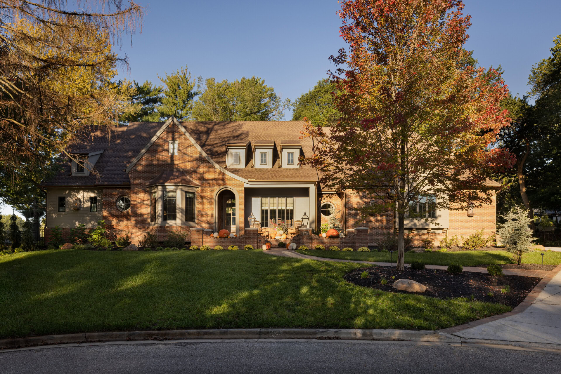 Cardinal Crest Homes Exterior Cardinal Crest Homes brick house with manicured lawn and fall trees.