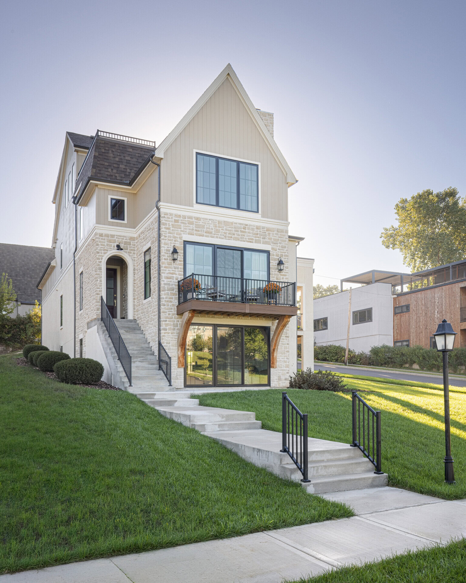 Cardinal Crest Home Exterior Cardinal Crest Homes modern multi-level house with stone facade and front porch.