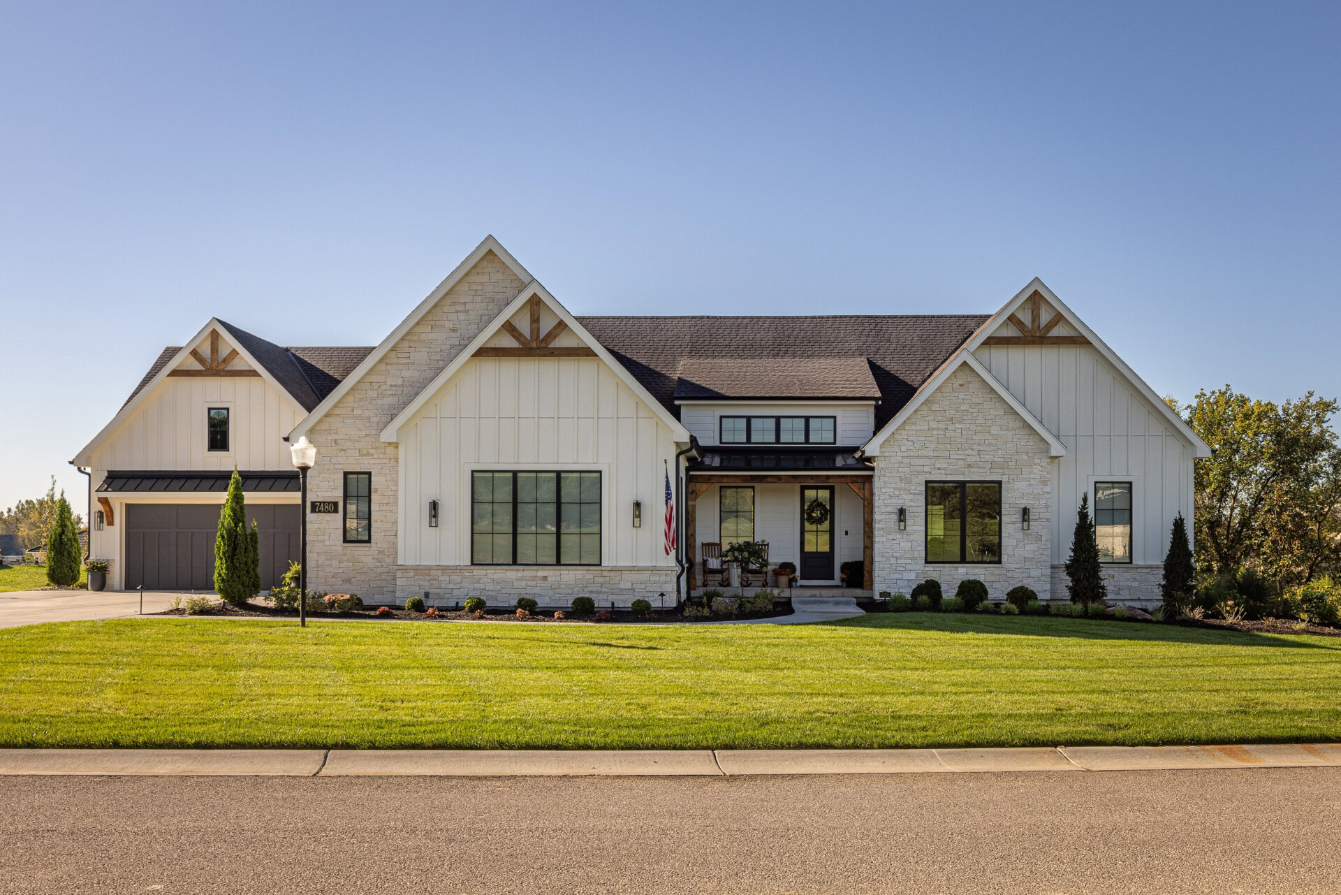 Cardinal Crest Homes Exterior Cardinal Crest Homes modern farmhouse-style exterior with stone accents and manicured lawn.