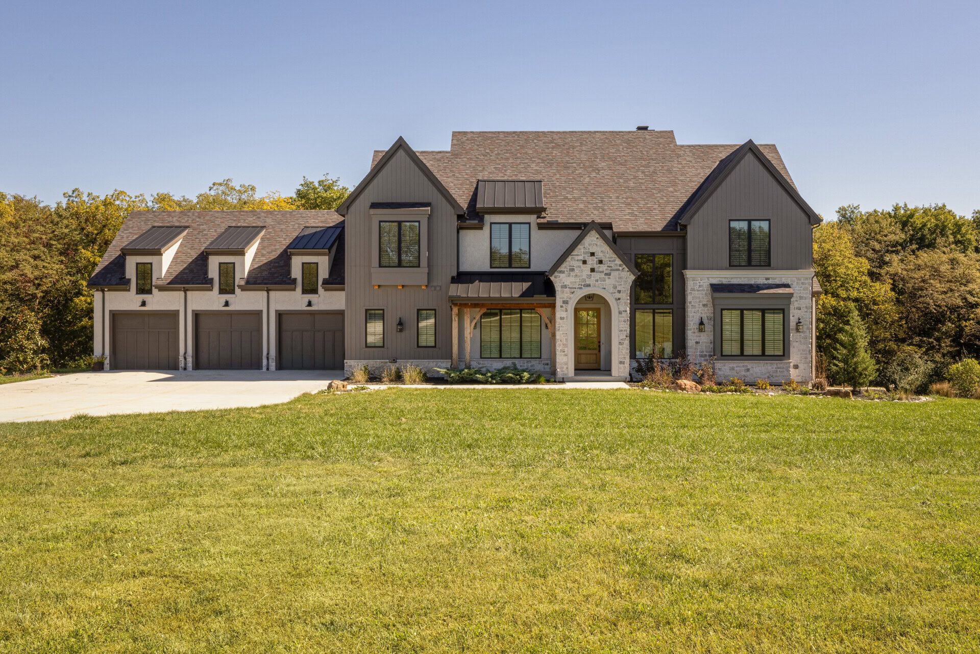 Cardinal Crest Homes property exterior Elegant modern home with stone facade and multiple garages.